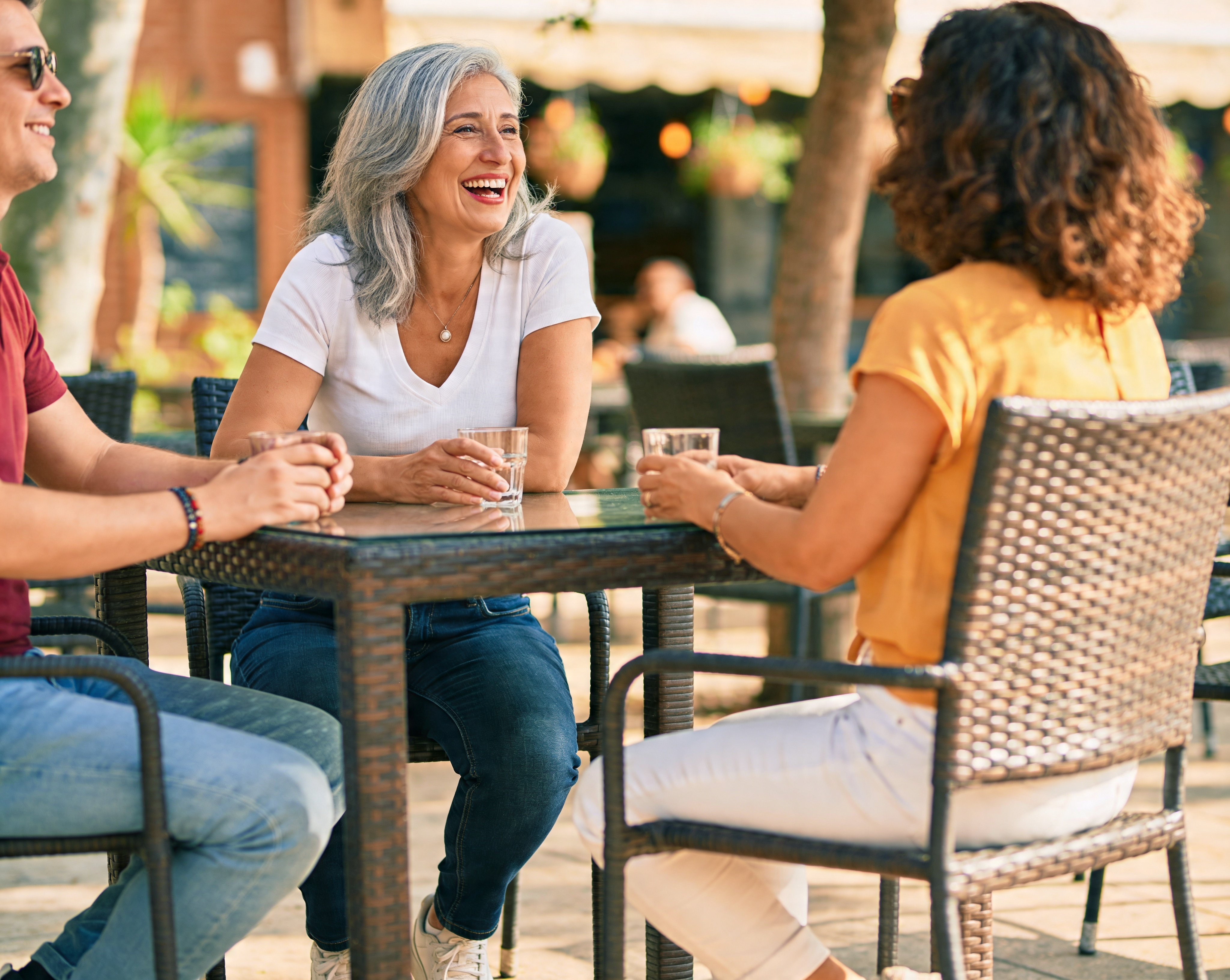Confident woman over 50 laughing with friends